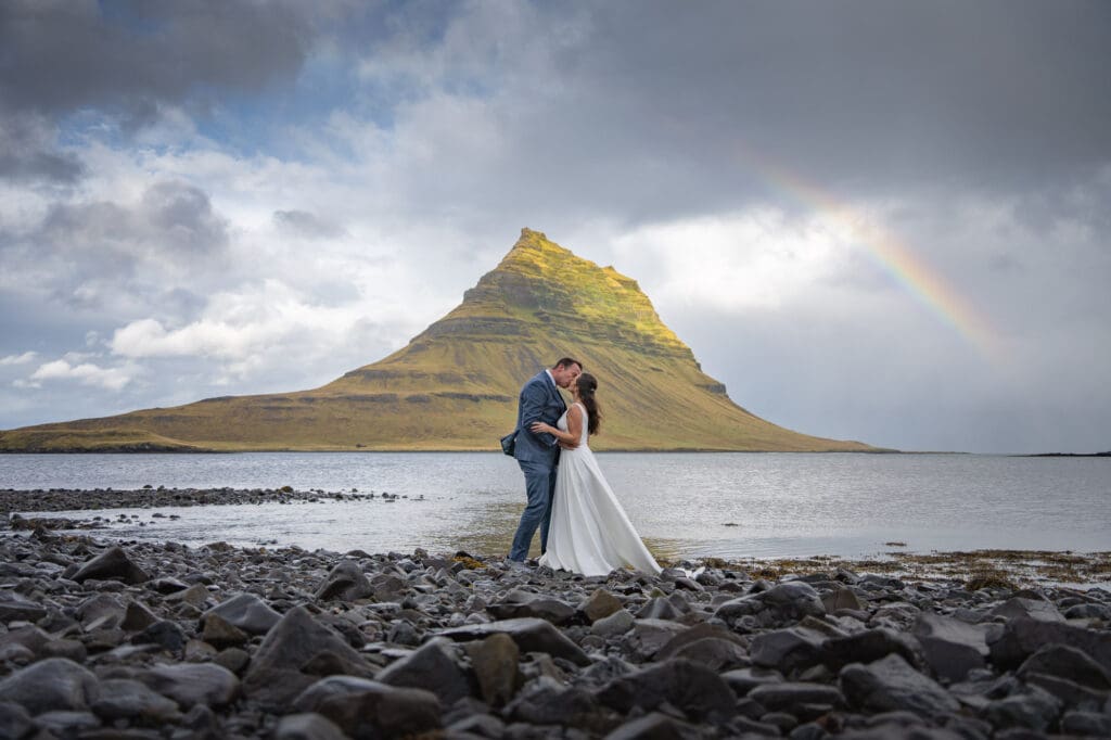 Elopement in front of Kirkjufell mountain in Iceland with a rainbow in the sky
