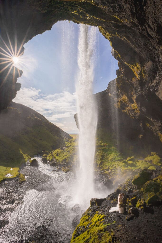Wedding couple behind Kvernufoss waterfall in Iceland