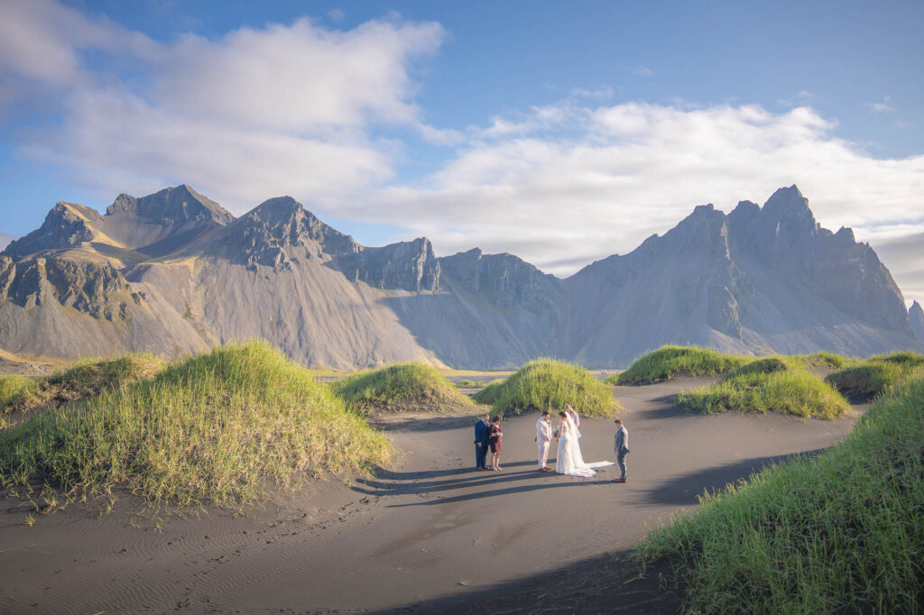 A view above on an Intimate wedding ceremony among black sand dunes of Stokksnes in Iceland