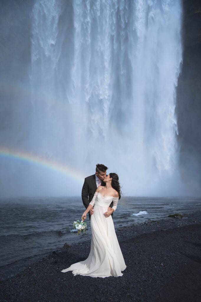 Elopement at Skogafoss waterfall in Iceland with a rainbow in the background
