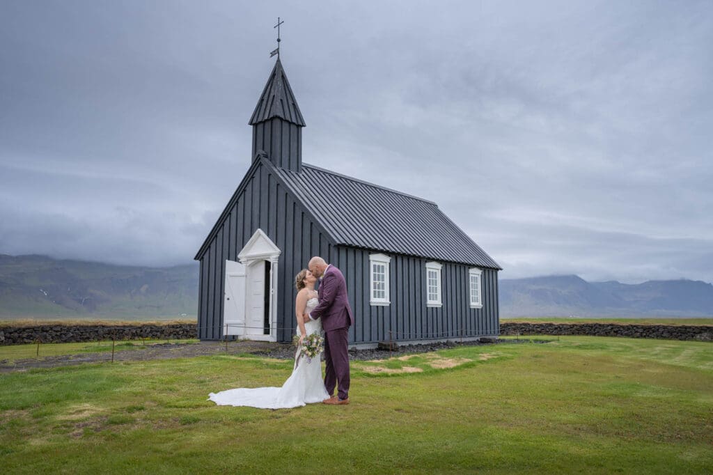 Wedding in front of black church in Iceland