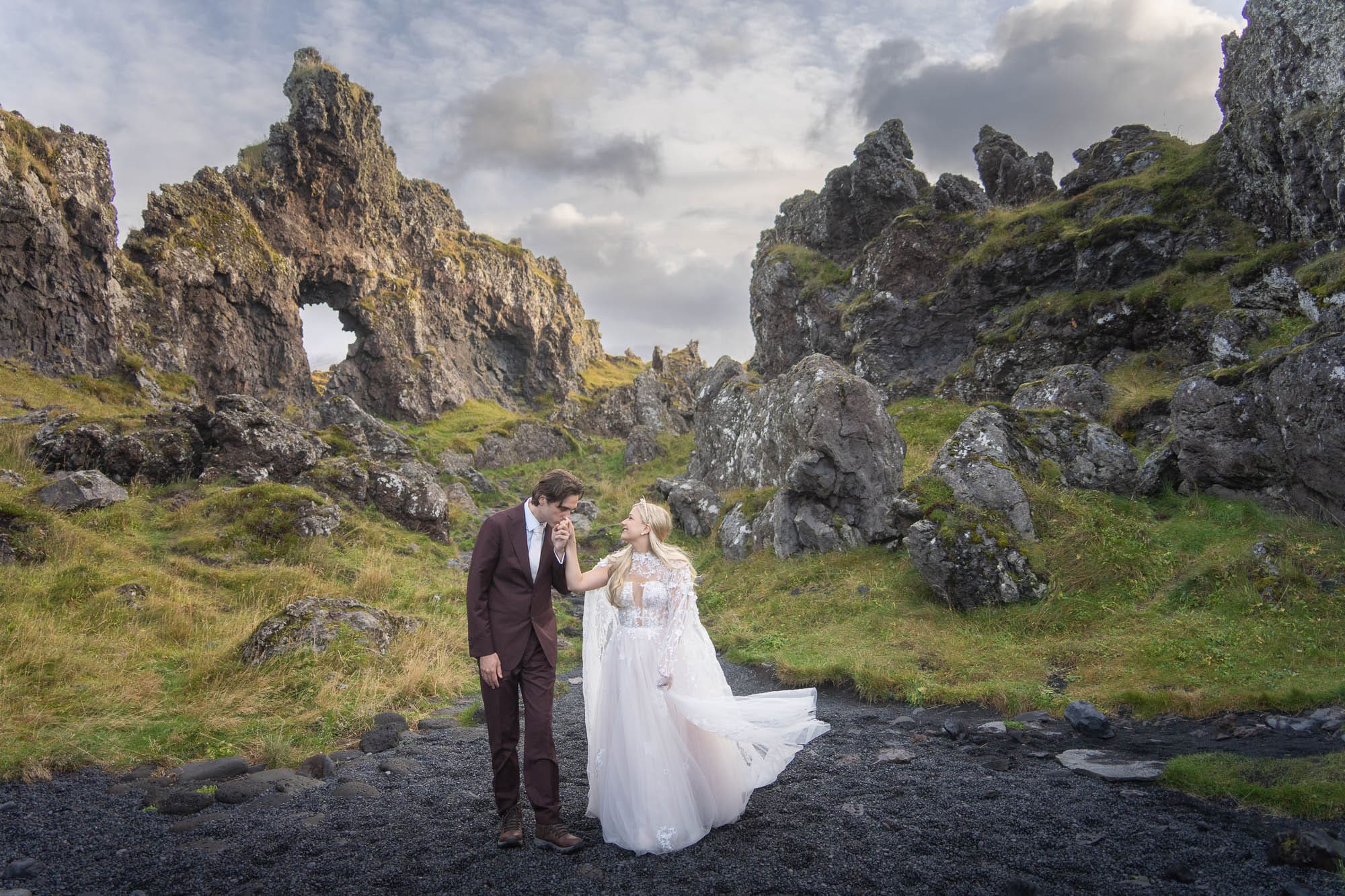Bride and groom in front of beautiful rock formations in Iceland