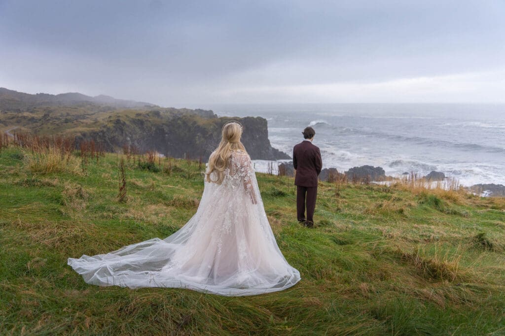 A couple is doing a first look by the ocean in Iceland before getting married